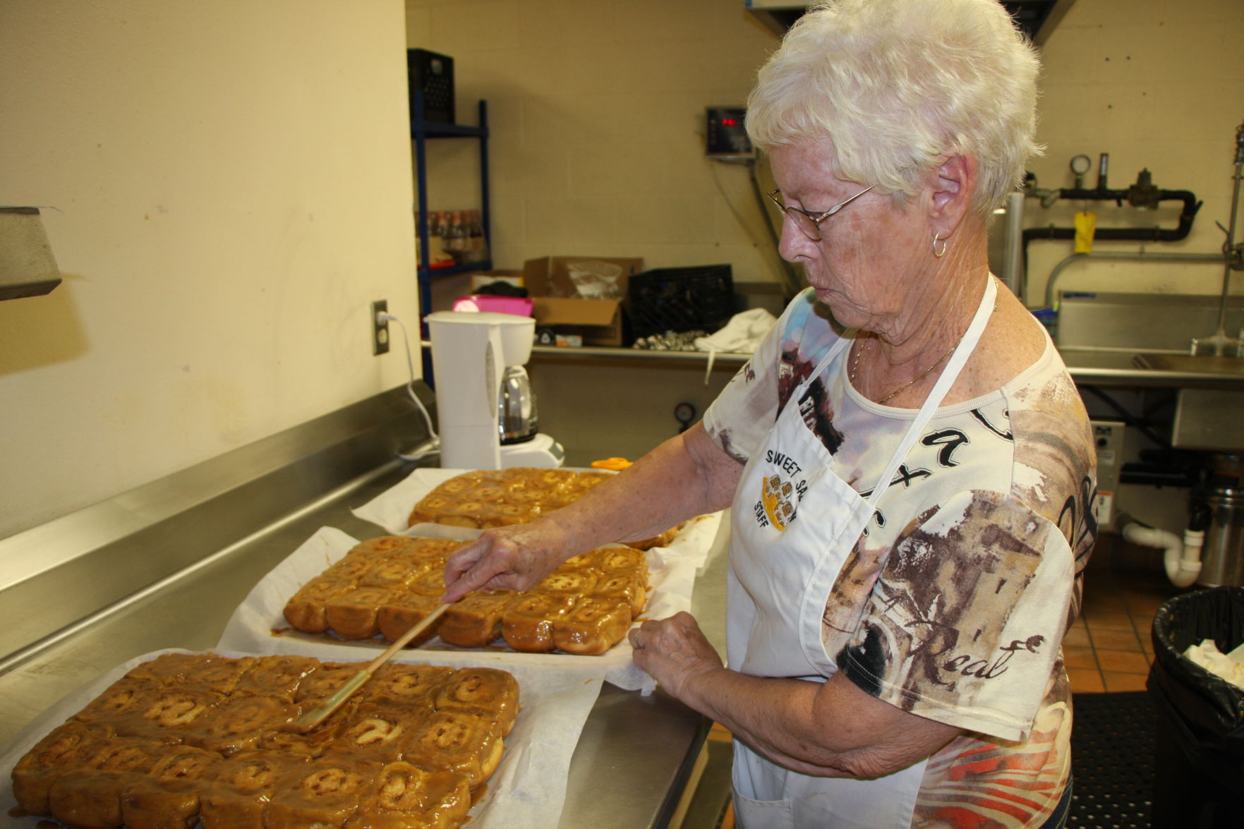 Doris Howard glazes rolls
